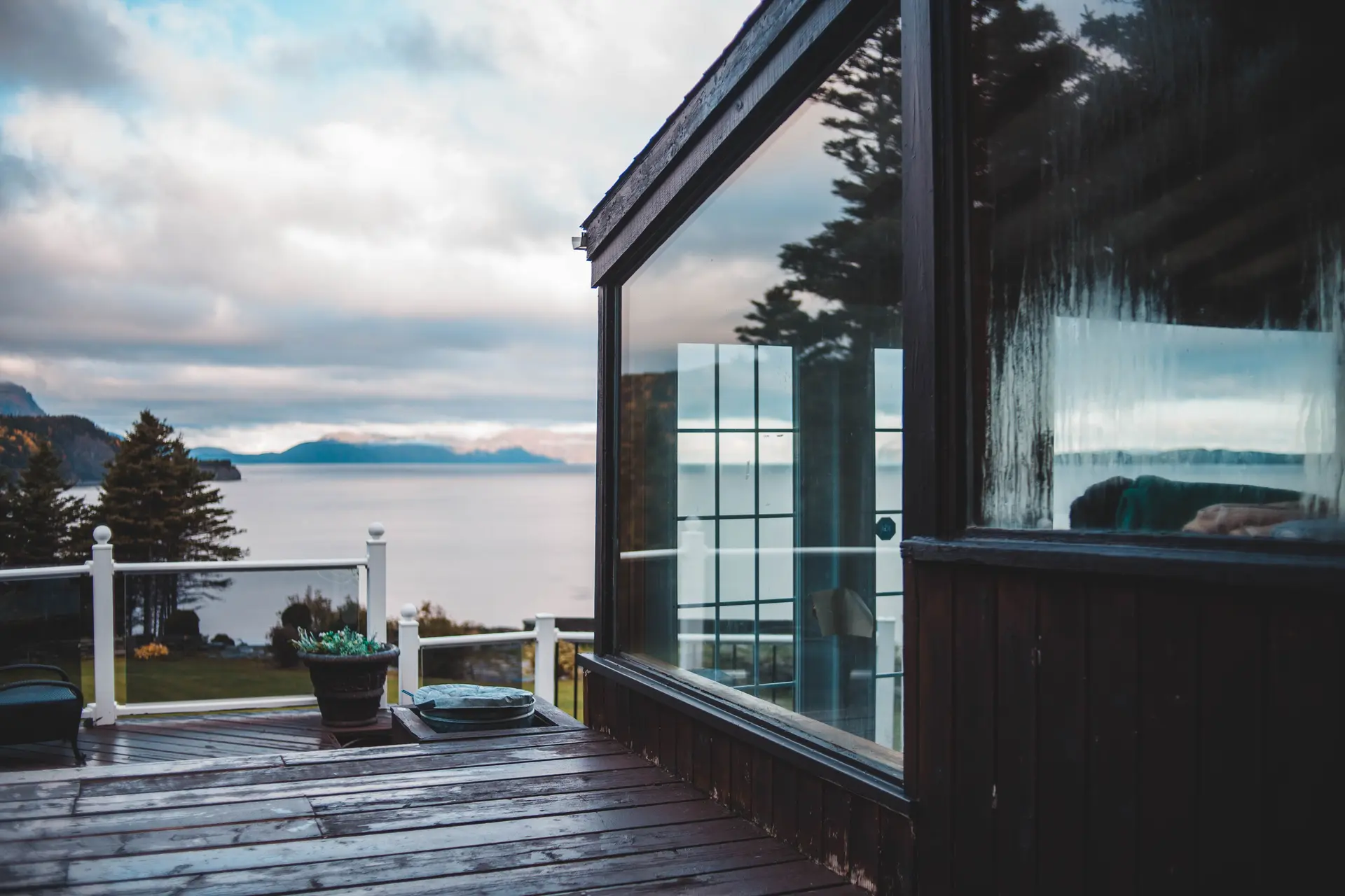 Wood deck and glass railing above the water