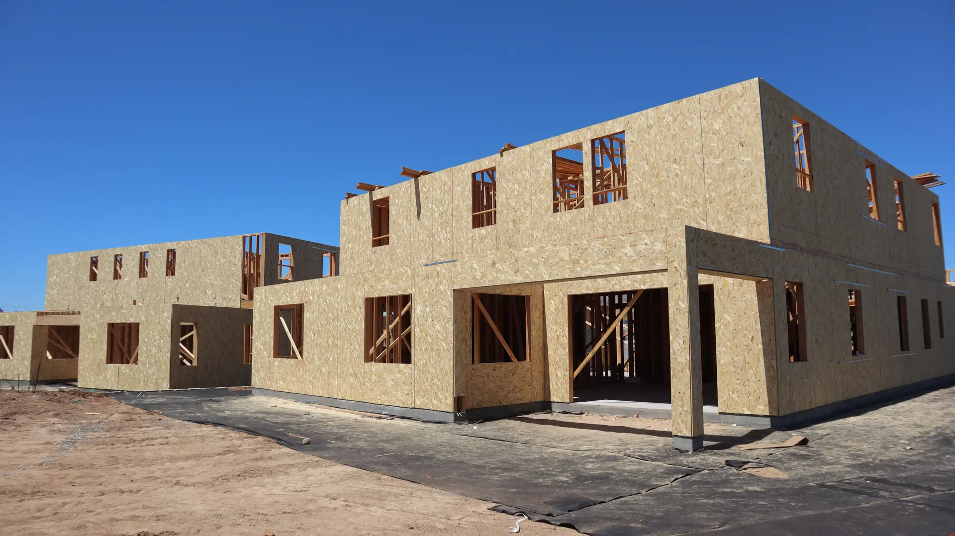 Two-story house sheathed in plywood during construction