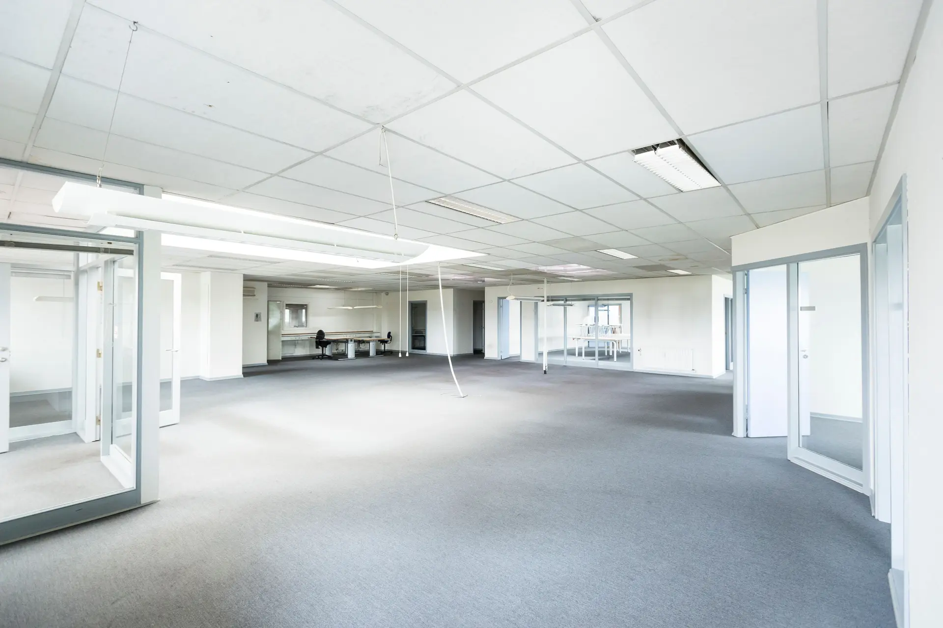 Empty office floor with new ceiling panels and glass partitions